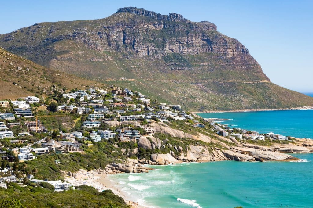 beautiful-shot-buildings-hill-turquoise-beach-cape-town-south-africa